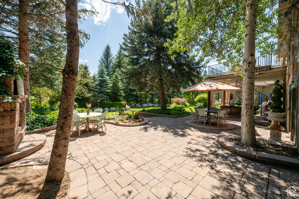 View of patio / terrace featuring outdoor dining area and stairs