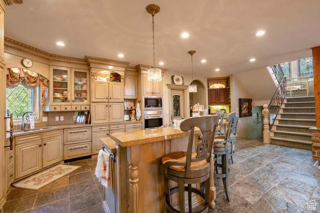 Kitchen featuring oven, recessed lighting, a sink, a kitchen island, and built in microwave