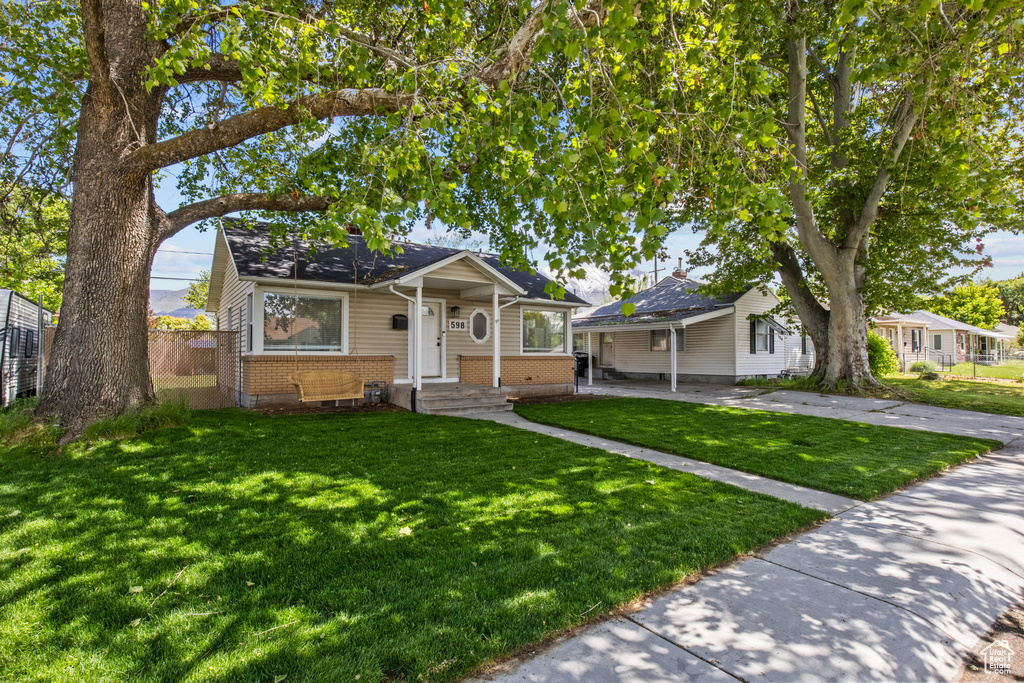 Bungalow featuring brick siding