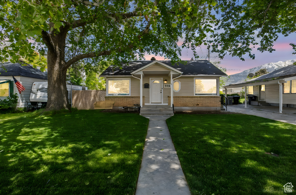 Bungalow-style home featuring brick siding and a patio