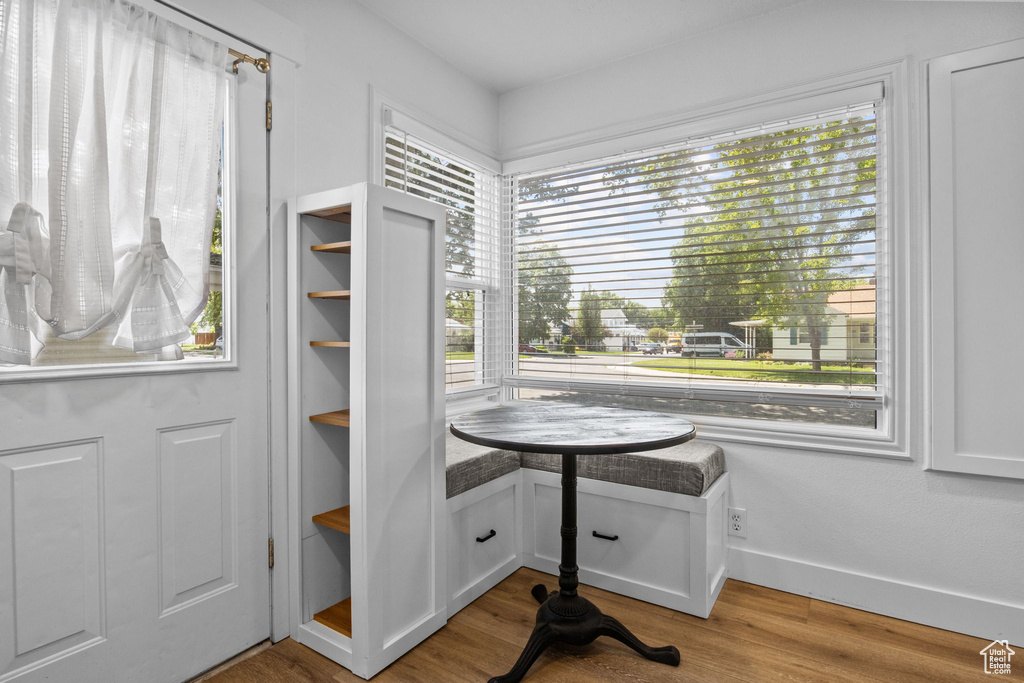 Dining area featuring plenty of natural light, wood finished floors, and baseboards