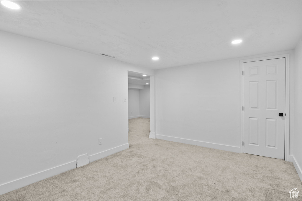 Spare room featuring recessed lighting, carpet flooring, and baseboards