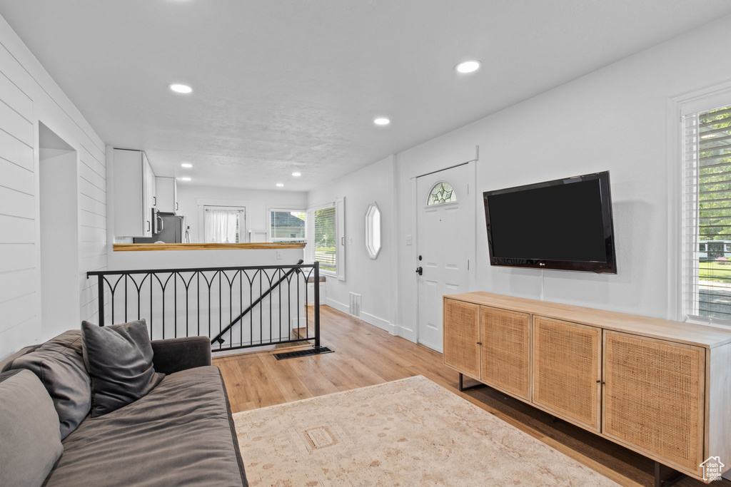 Living room featuring light wood-style floors and recessed lighting