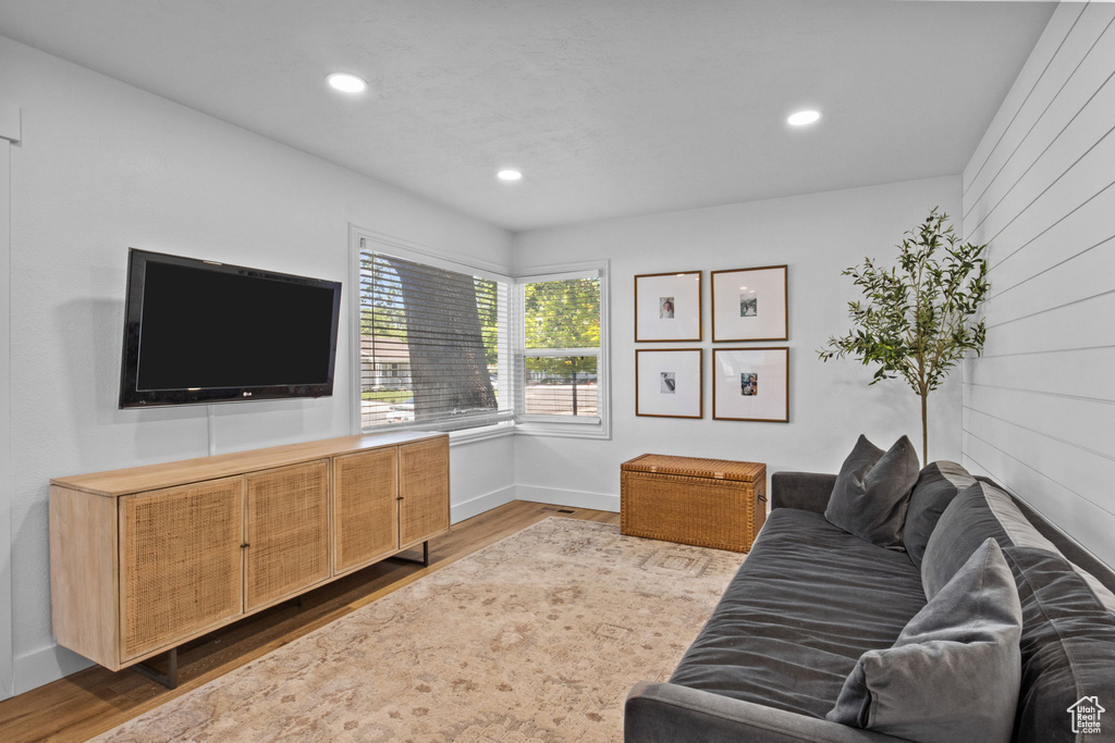 Living room featuring wood finished floors, baseboards, and recessed lighting