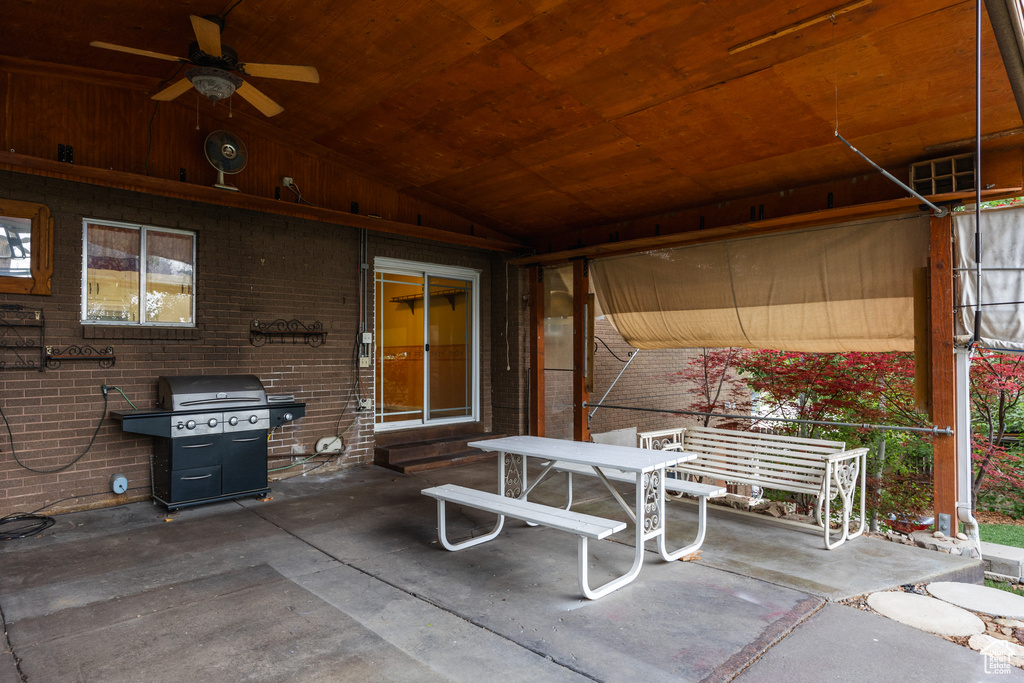 View of patio with a ceiling fan and outdoor dining area