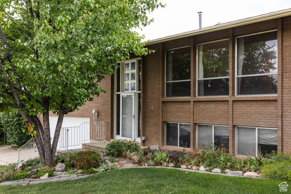 View of building exterior featuring a garage and concrete driveway