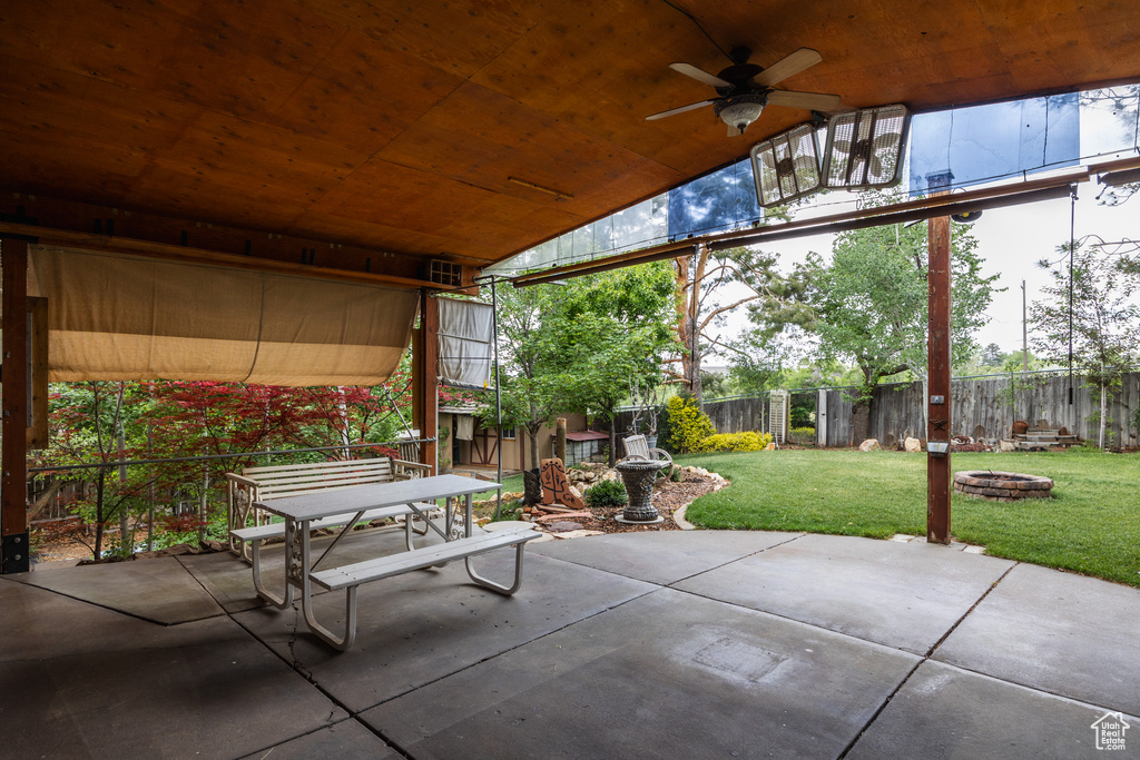 View of patio / terrace featuring a fire pit, outdoor dining area, and ceiling fan