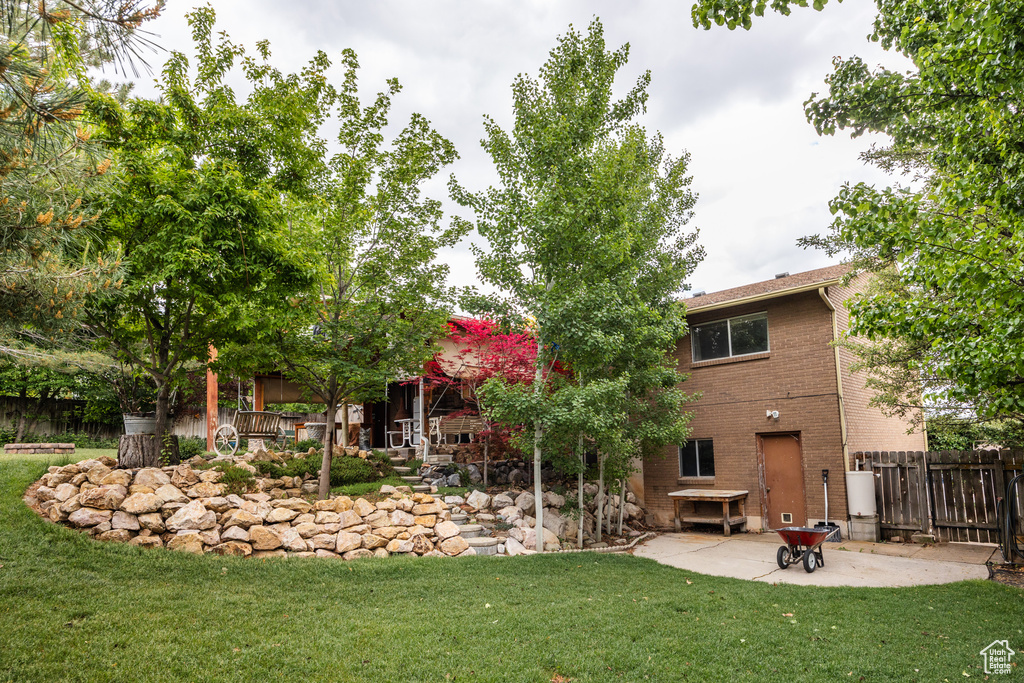 Rear view of house with a patio area and brick siding