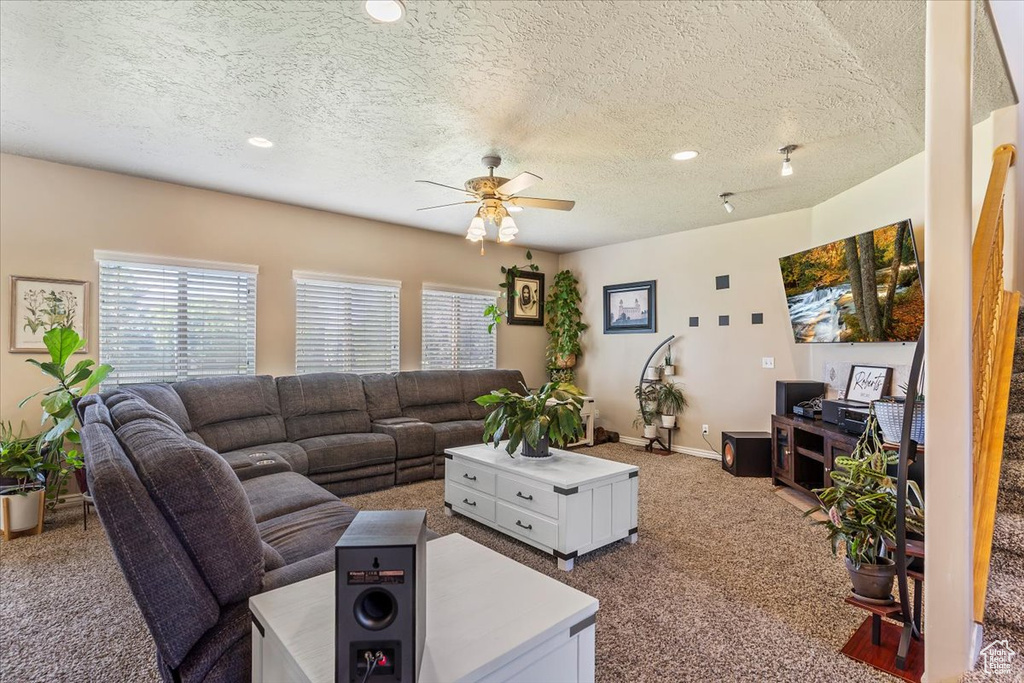 Living area with ceiling fan, carpet, plenty of natural light, a textured ceiling, and recessed lighting