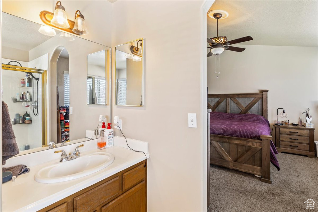 Bathroom with ceiling fan, vanity, ensuite bath, and an enclosed shower