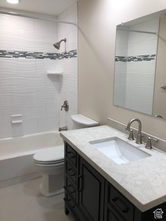 Bathroom featuring vanity, toilet, bathing tub / shower combination, and tile patterned floors