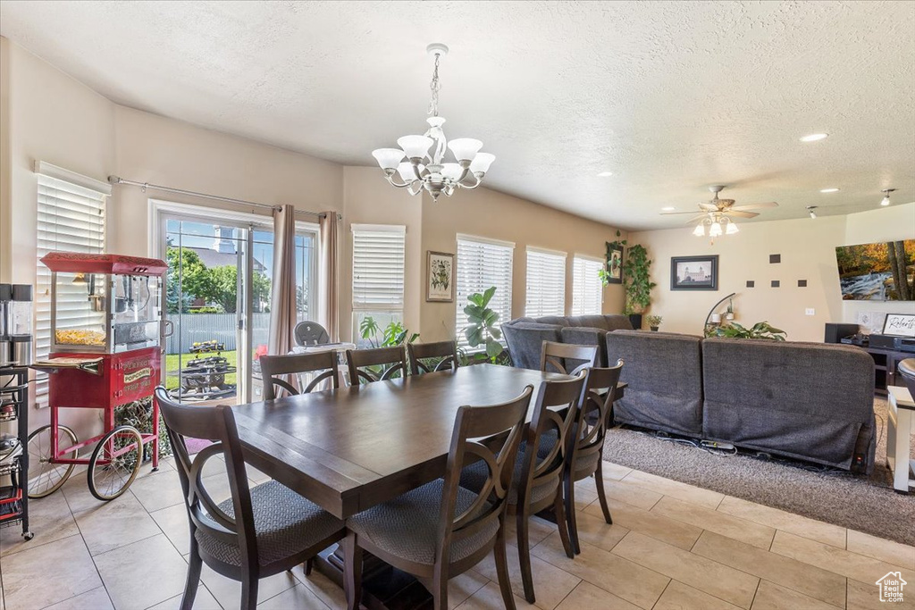Dining room featuring a textured ceiling, a chandelier, ceiling fan, light tile patterned floors, and recessed lighting