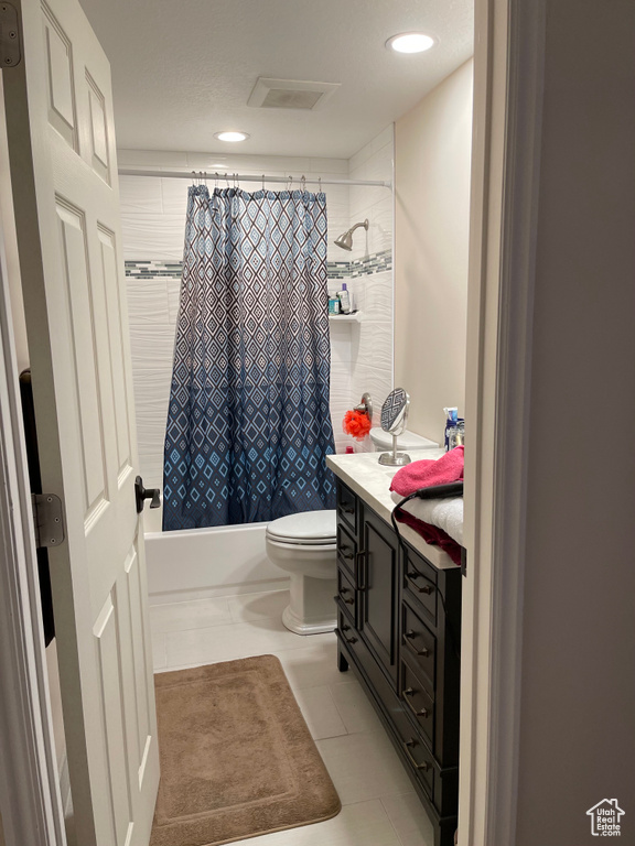 Bathroom featuring toilet, vanity, shower / bath combo, recessed lighting, and tile patterned flooring