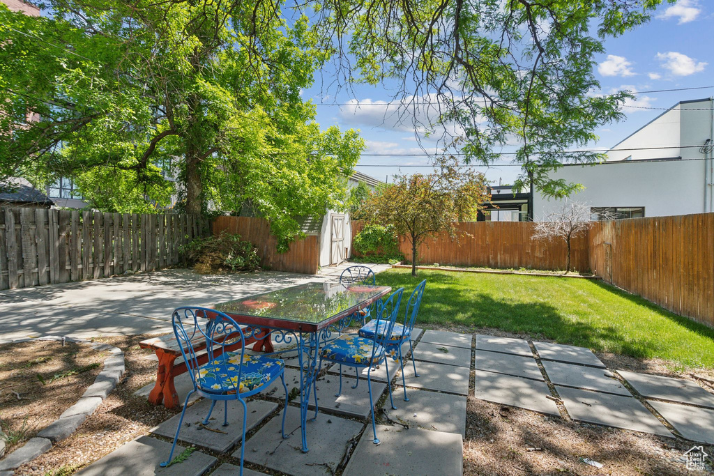 View of patio / terrace featuring outdoor dining space and an outbuilding