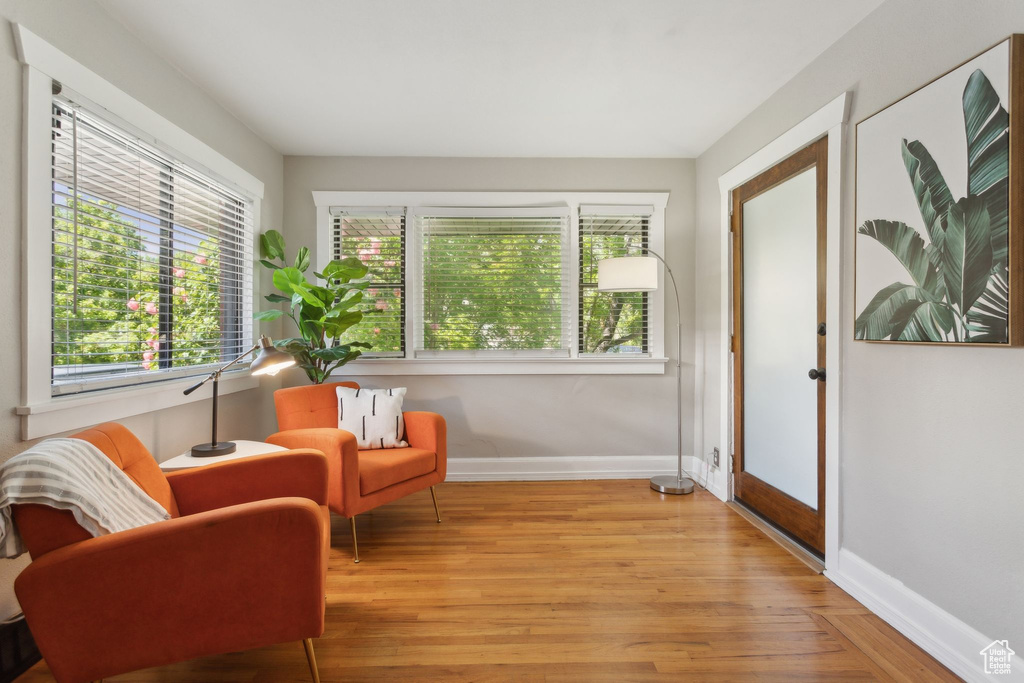 Living area with baseboards and light wood-style flooring