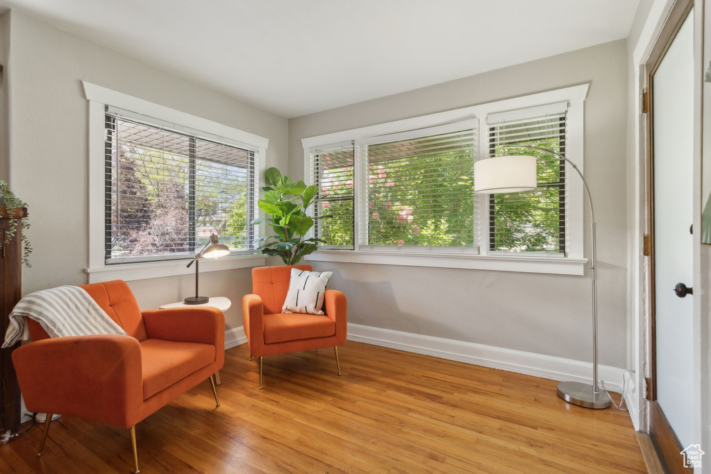 Living area featuring light wood-style floors and baseboards