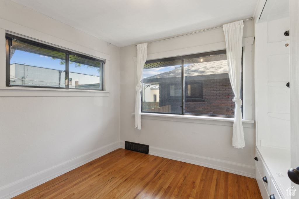 Spare room with baseboards and light wood finished floors