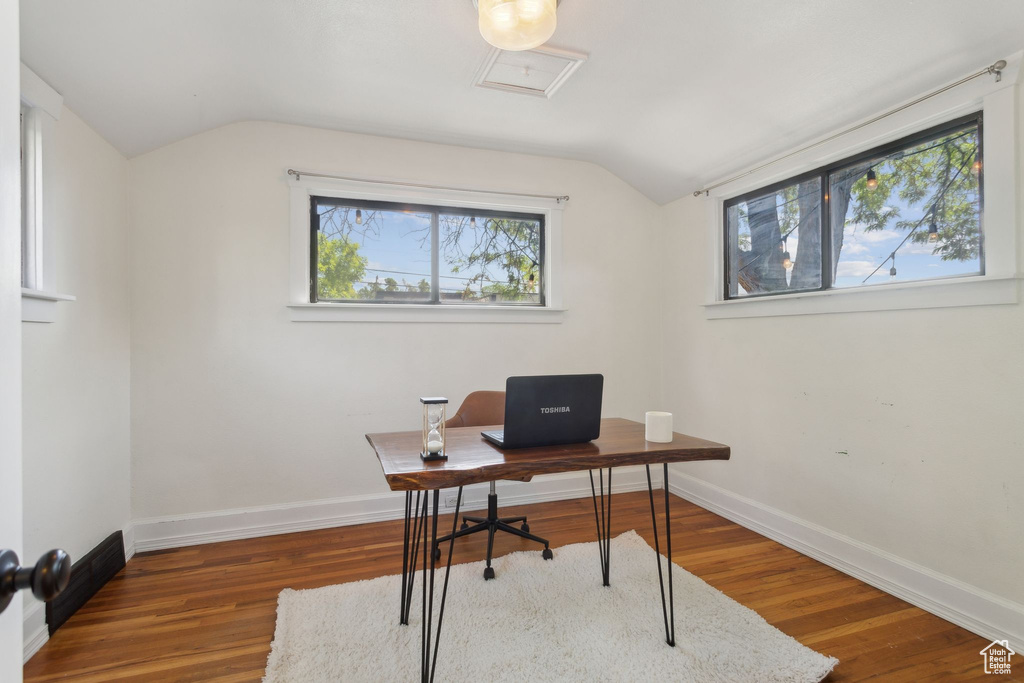 Office area with lofted ceiling, wood finished floors, and baseboards