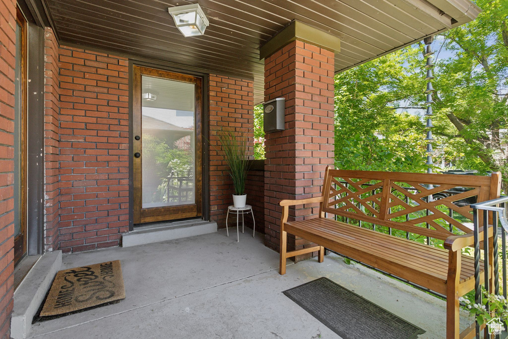 View of exterior entry with brick siding