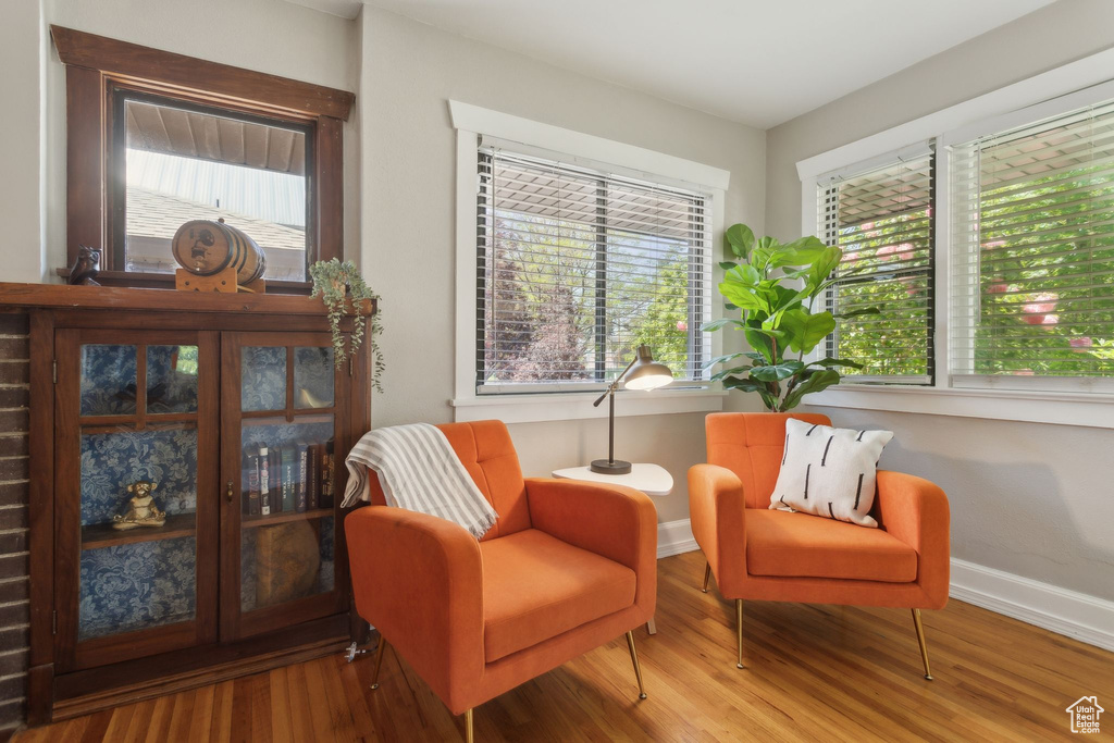 Sitting room with wood finished floors and baseboards