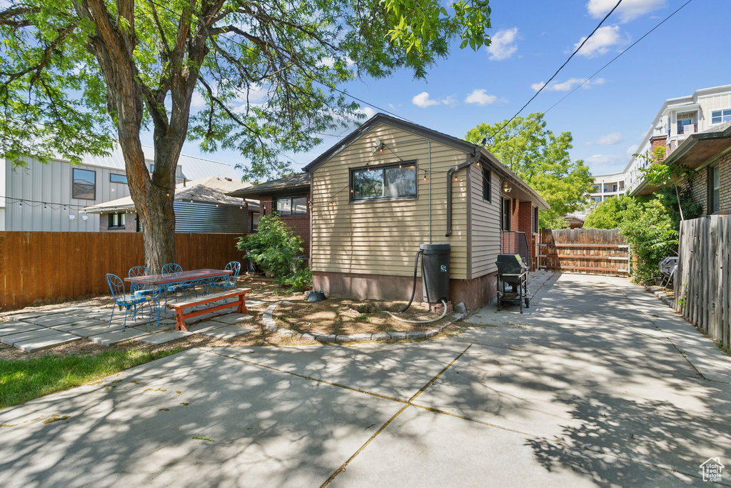 Rear view of house featuring a patio area and outdoor dining space