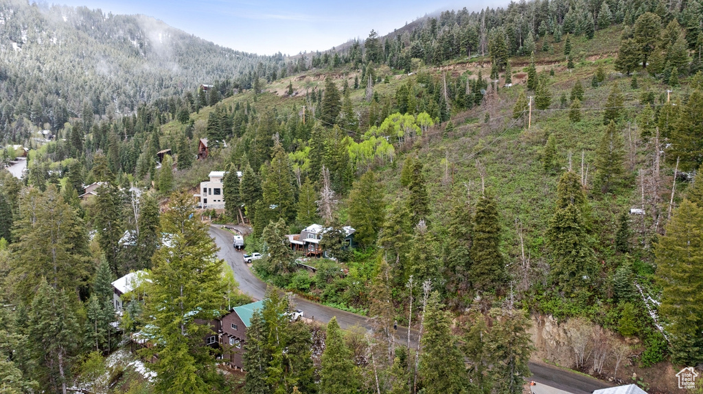 View of property location with a forest and a mountain backdrop