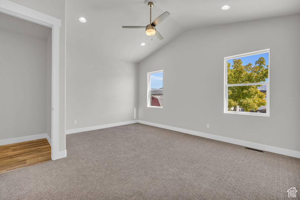 Unfurnished bedroom with carpet flooring, recessed lighting, lofted ceiling, baseboards, and a ceiling fan