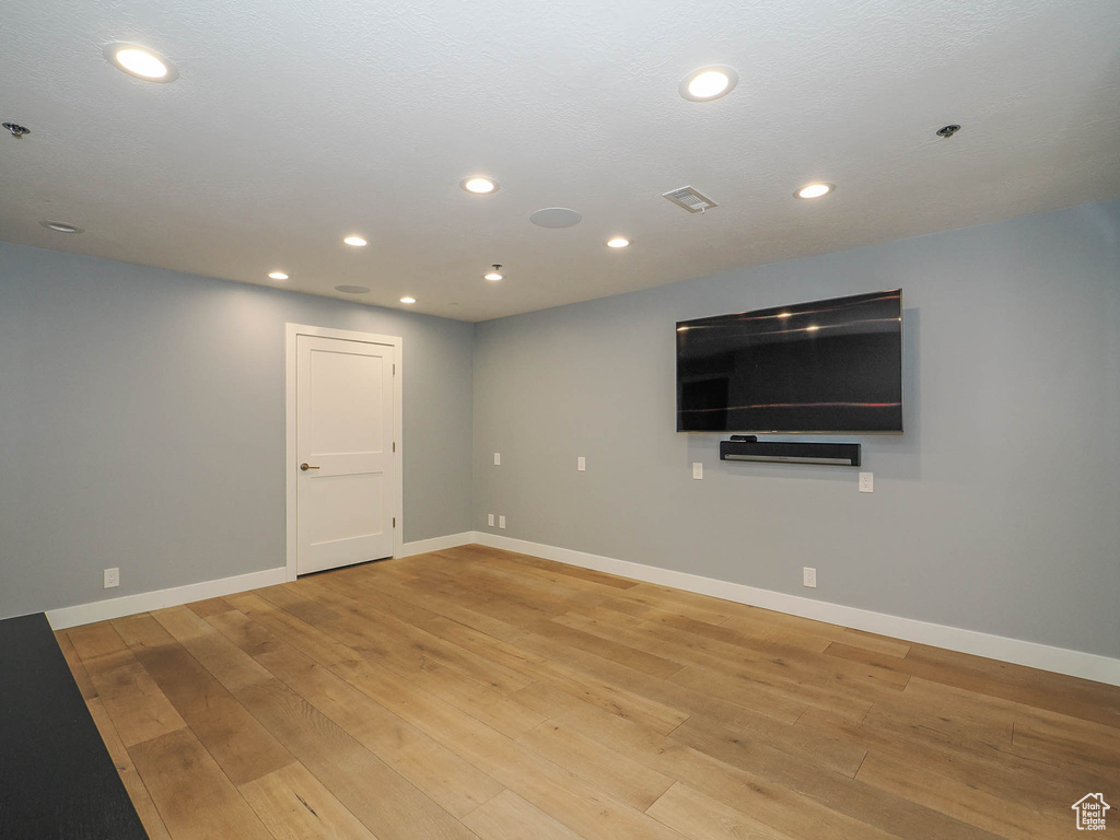Below grade area featuring light wood finished floors, baseboards, and recessed lighting