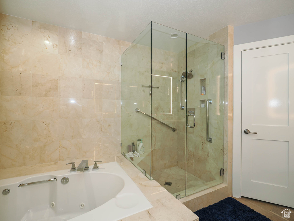 Bathroom featuring a shower stall and a whirlpool tub