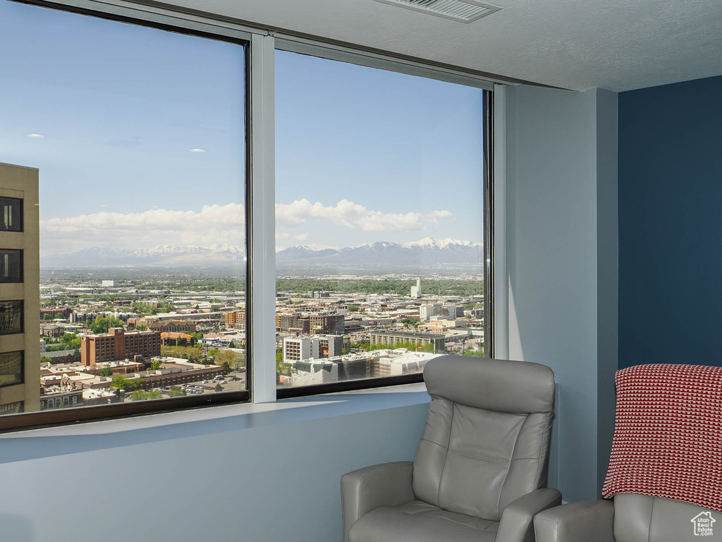 Sitting room featuring a city view and a mountain view