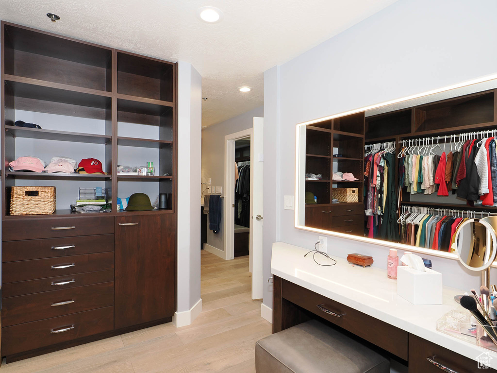 Spacious closet with light wood-type flooring