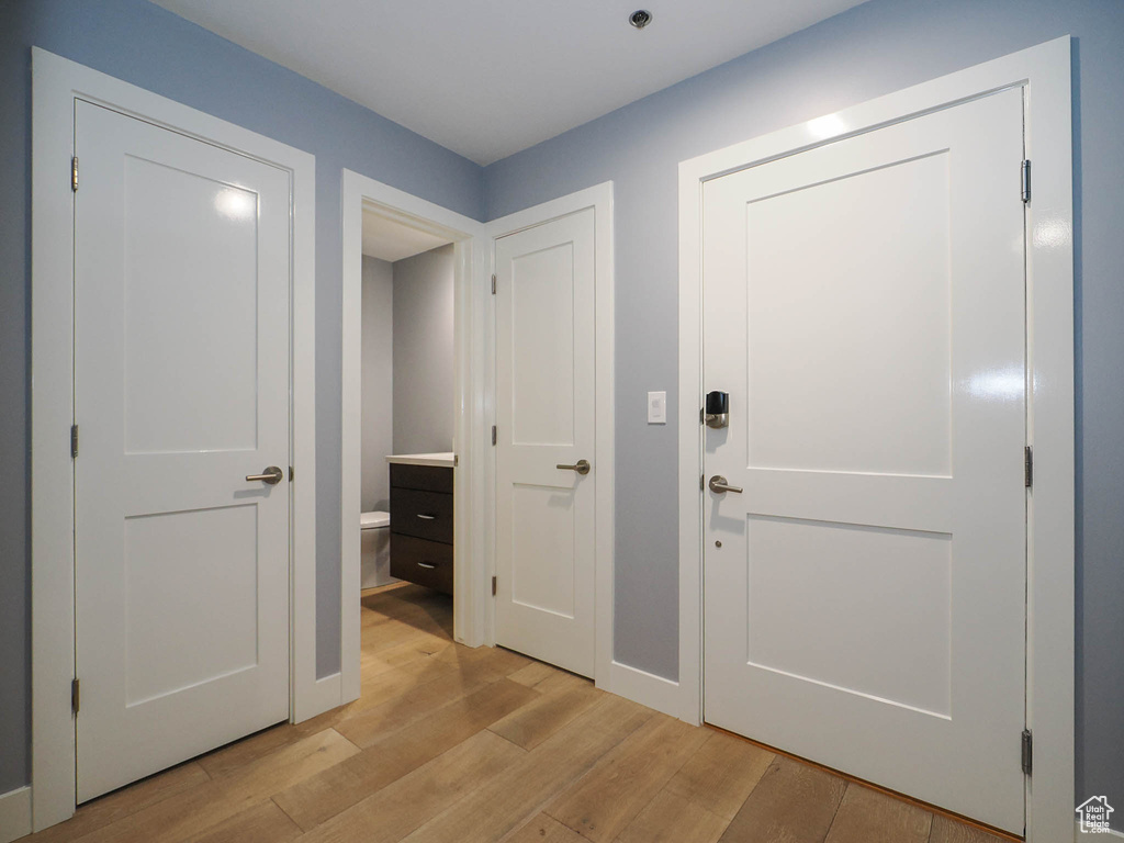 Foyer with light wood-type flooring and baseboards