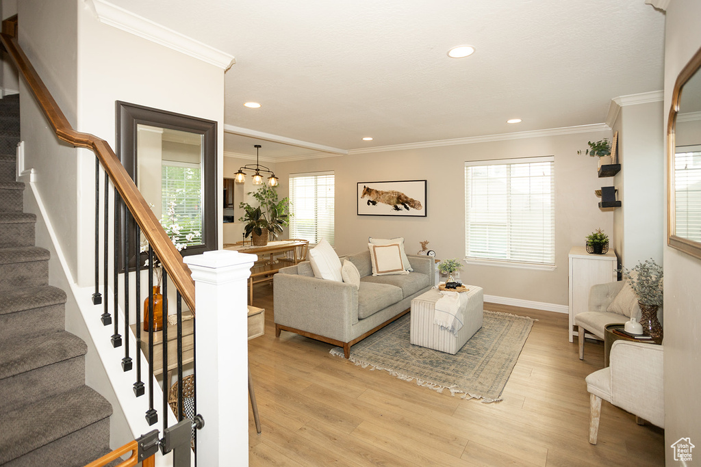 Living room featuring ornamental molding, stairs, light wood-style floors, recessed lighting, and baseboards
