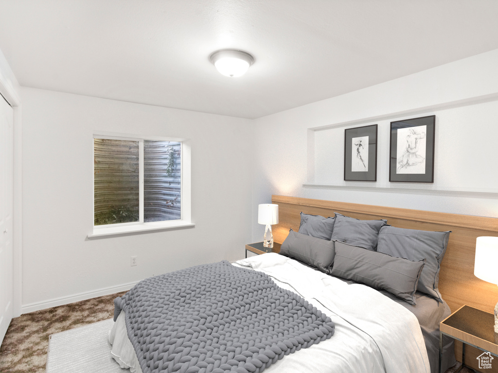 Bedroom with carpet flooring and baseboards