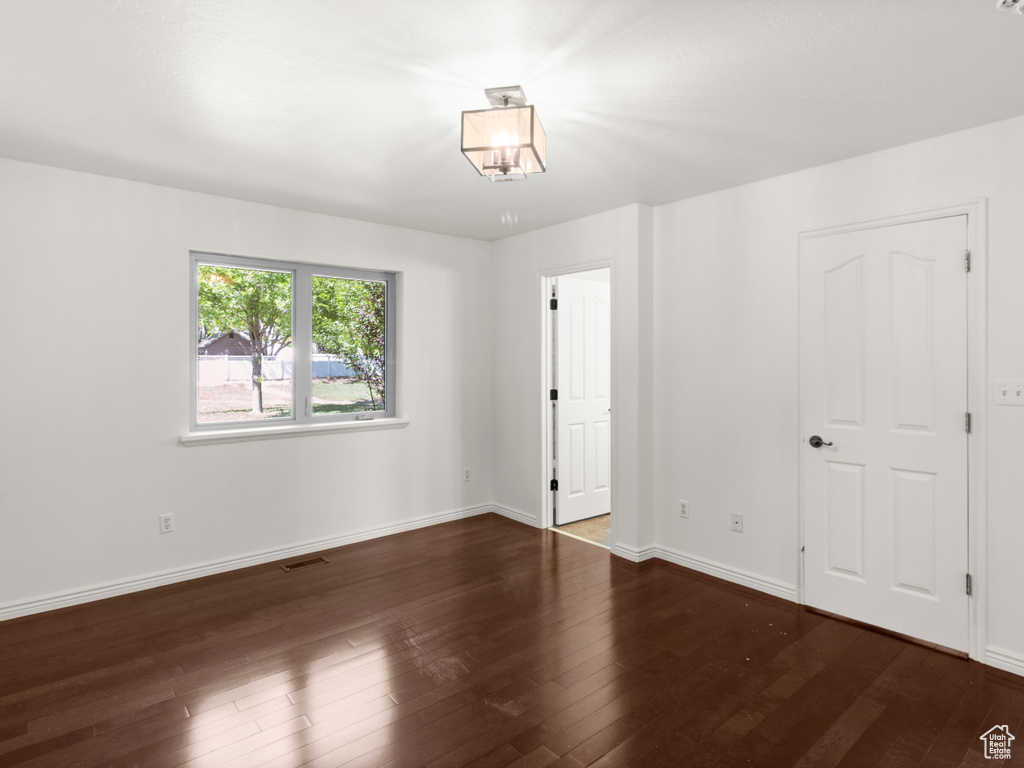 Unfurnished bedroom featuring wood finished floors and baseboards