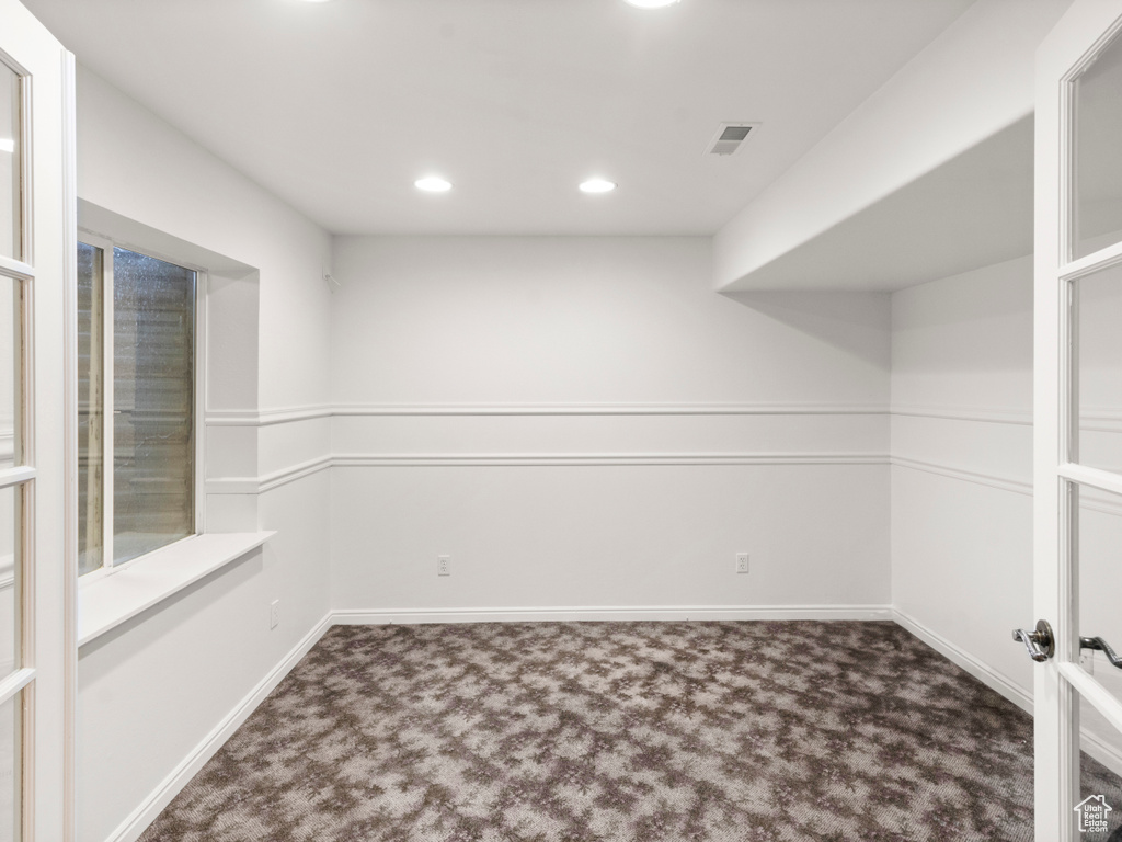 Carpeted empty room with recessed lighting and baseboards