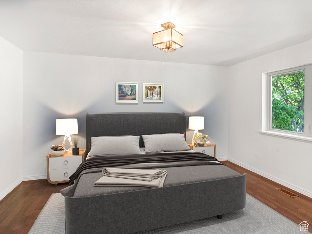 Bedroom featuring wood finished floors and baseboards