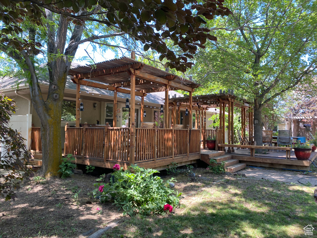 View of yard featuring a pergola and a deck