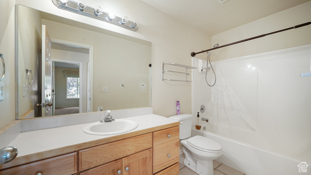 Full bathroom with  shower combination, toilet, vanity, and tile patterned flooring