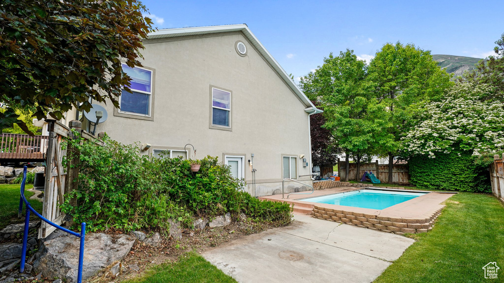 View of pool with a patio and a deck