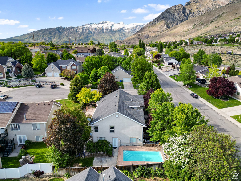 Aerial perspective of suburban area with mountains and a pool