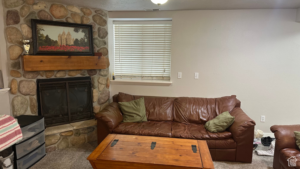 Living room featuring carpet and a fireplace