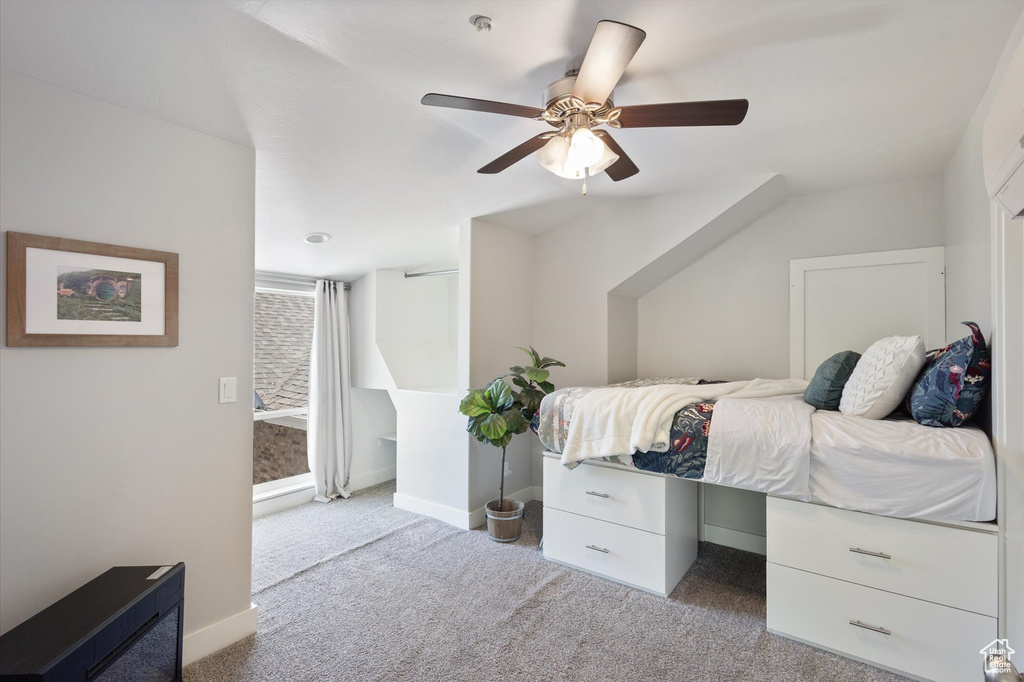 Carpeted bedroom featuring baseboards and ceiling fan