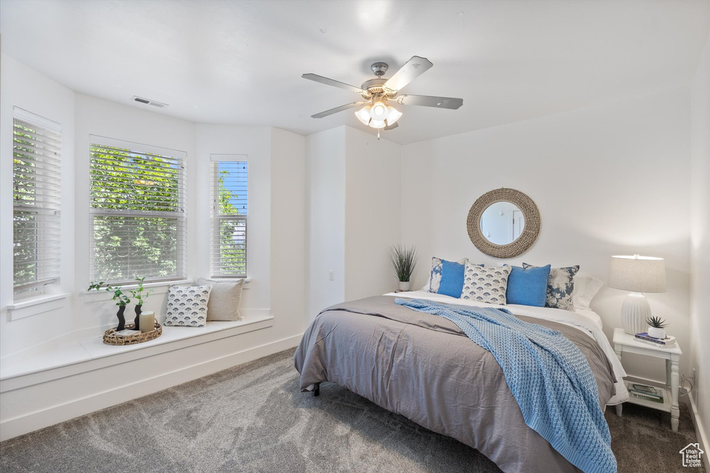 Bedroom with carpet, ceiling fan, and baseboards