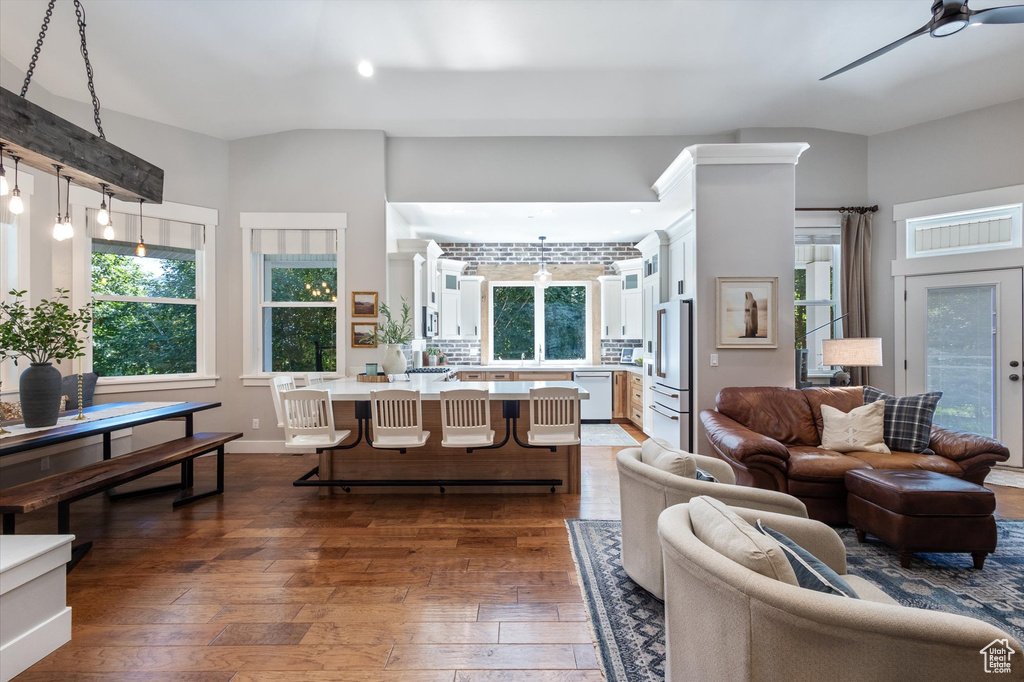 Living room with dark wood finished floors, ceiling fan, and recessed lighting