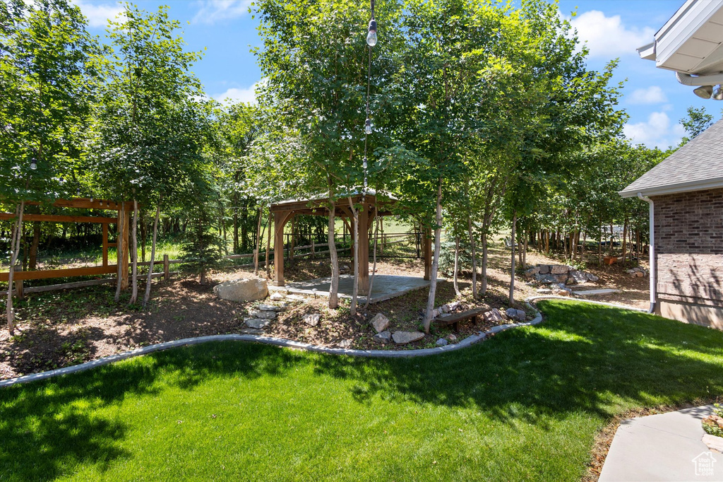 View of grassy yard featuring a gazebo