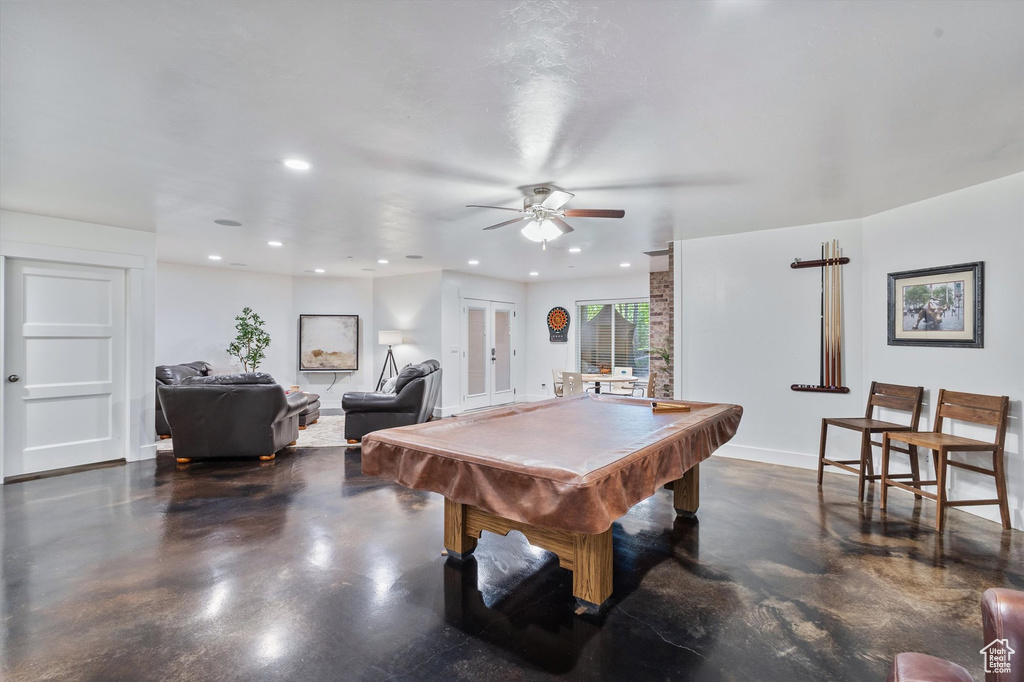 Rec room with finished concrete floors, recessed lighting, ceiling fan, billiards table, and baseboards