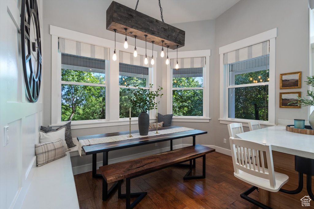 Dining space with dark wood finished floors and baseboards