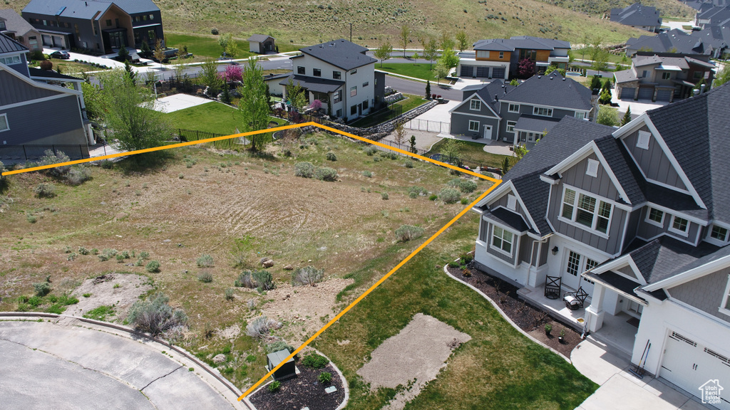 Aerial perspective of suburban area with property boundaries highlighted and mountains