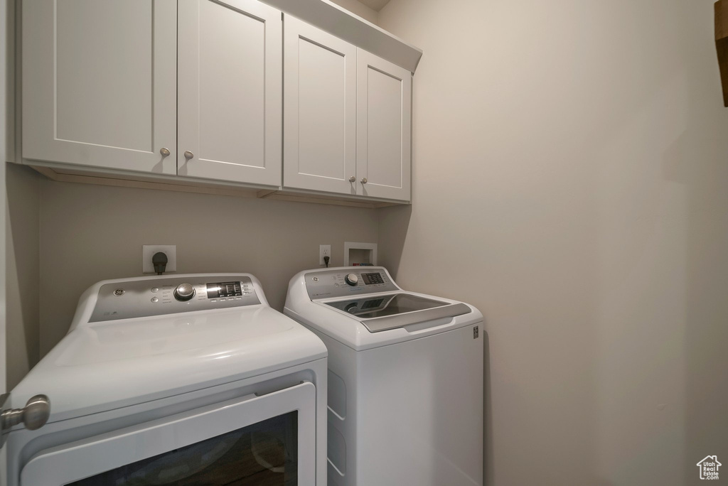 Laundry area with independent washer and dryer and cabinet space